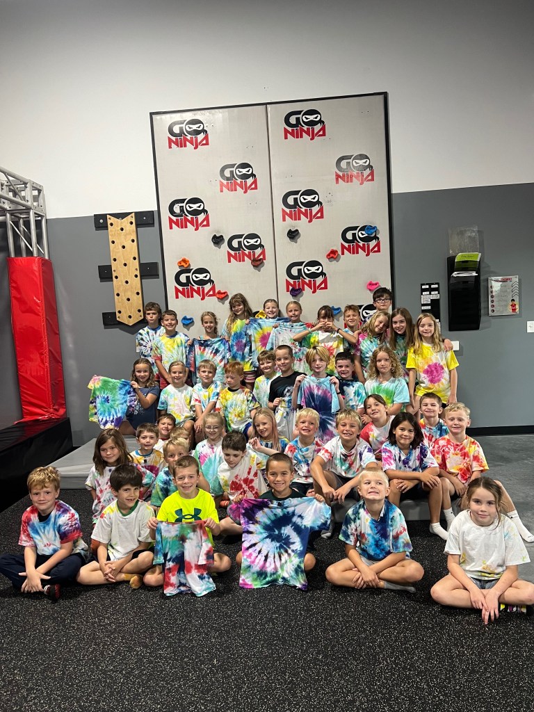 Summer camp group photo with tie-dye shirts