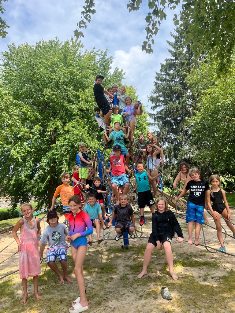 Camp kids on playground pyramid